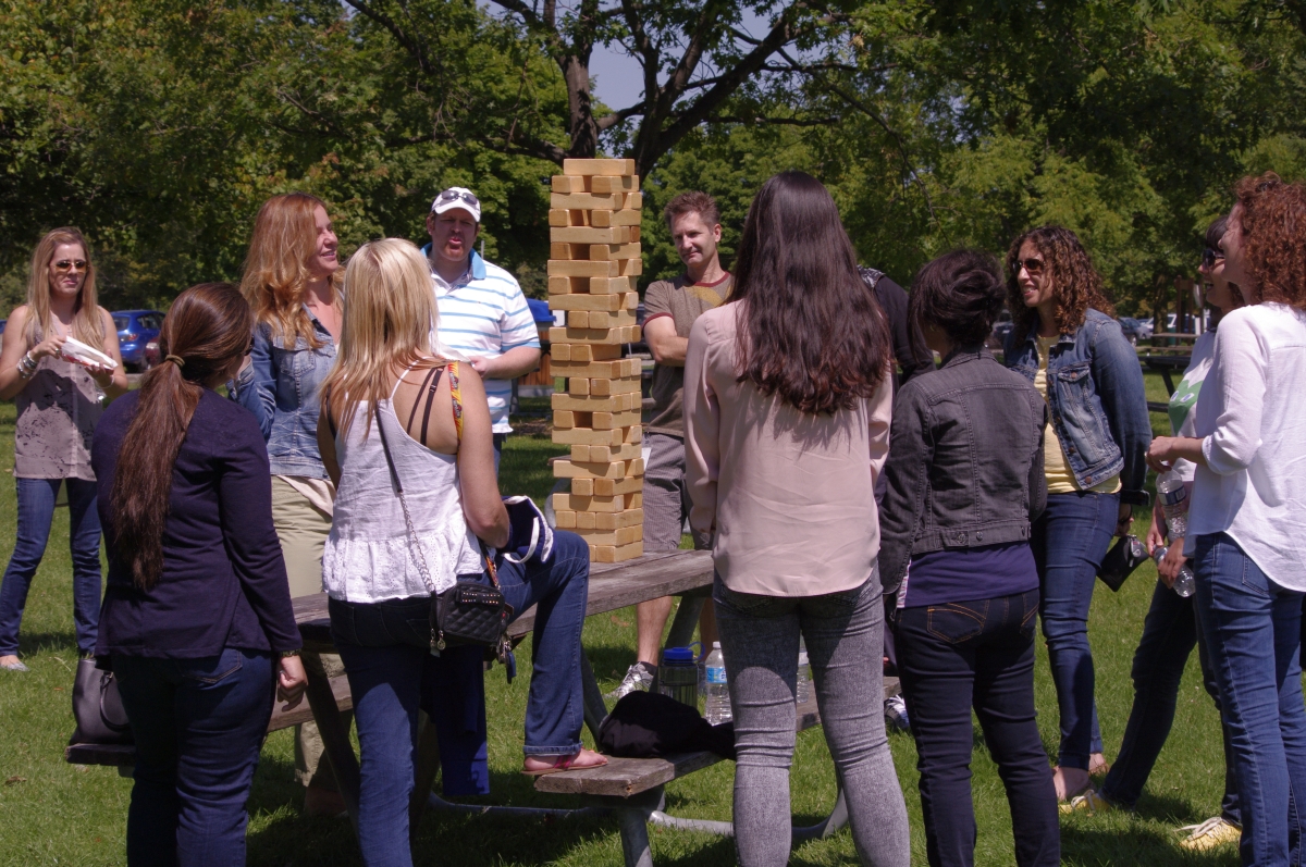Adults enjoying a game of giant jenga at party