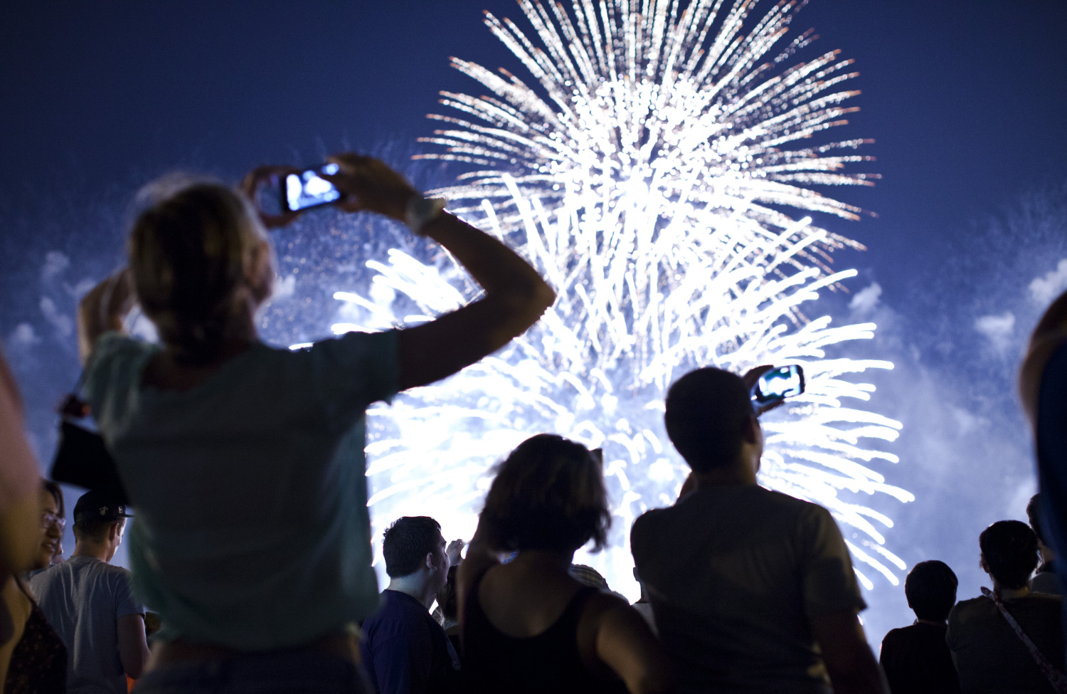 People Recording Fireworks Display